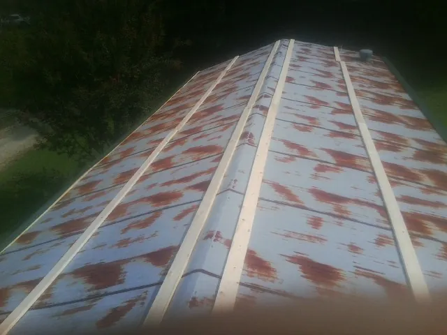 Rusted metal roof panels with new wood purlins before replacement — Storm Damage Roof Repair in Fountain Valley by Roofing Brothers